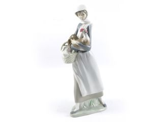 An elegant Lladro, Spain porcelain figurine of a country girl carrying
